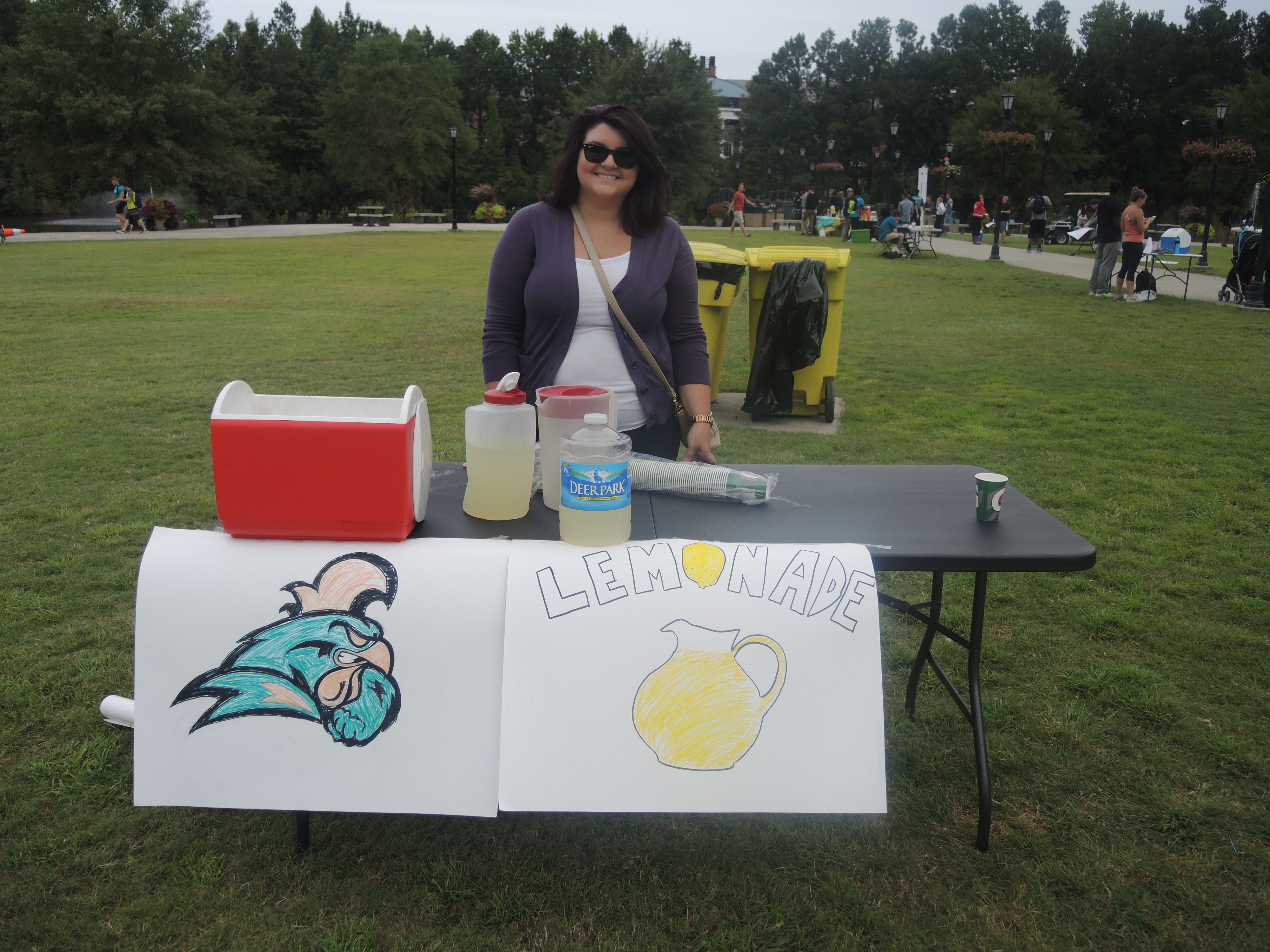 This student is at her lemonade stand solo because her group members are out and about convincing staff and faculty members to come purchase their drink.