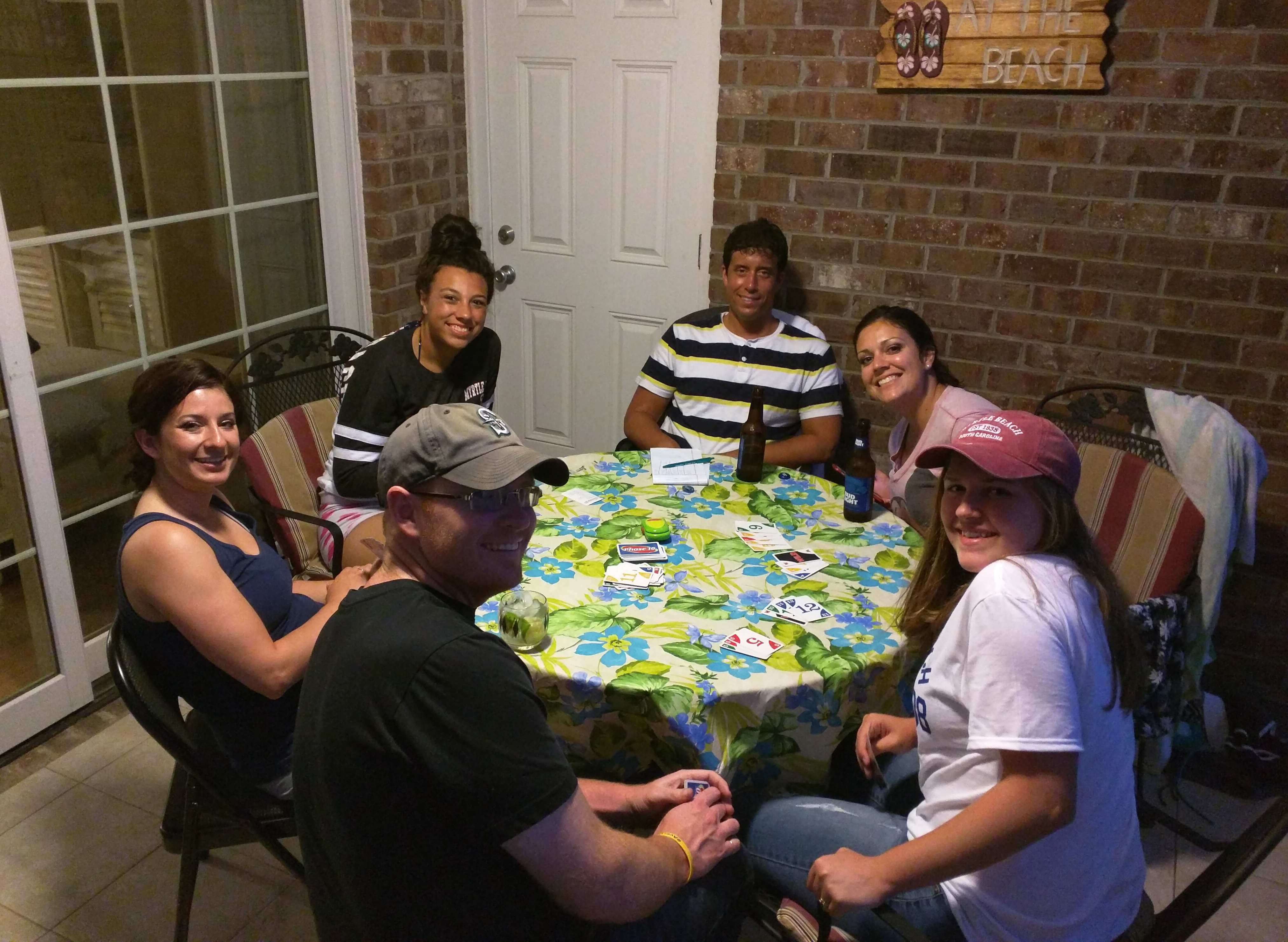 A group of us playing Phase 10 out on the condo porch area (photo credit to Jay).
