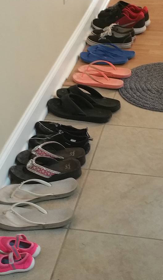 This line of shoes right inside the condo helps to show the amount of people who stayed under that roof (photo credit to Nancy).
